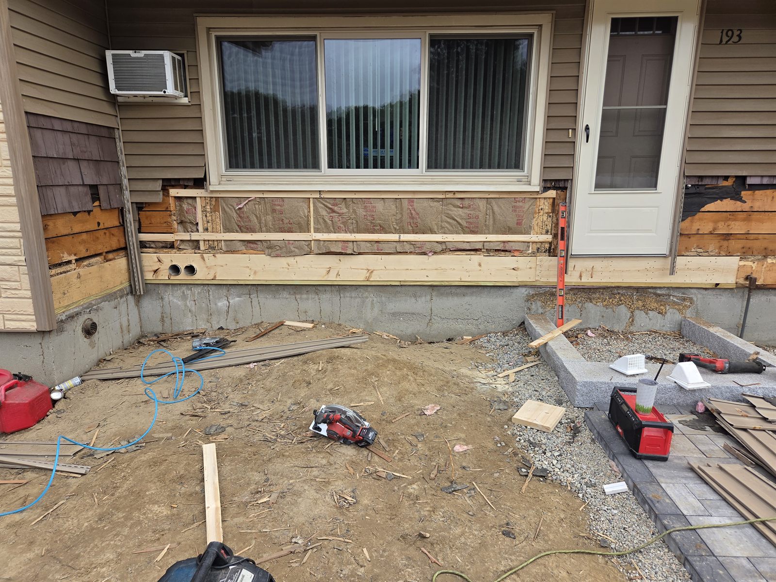 Before — framed exterior wall repair under a window in Sutton, MA