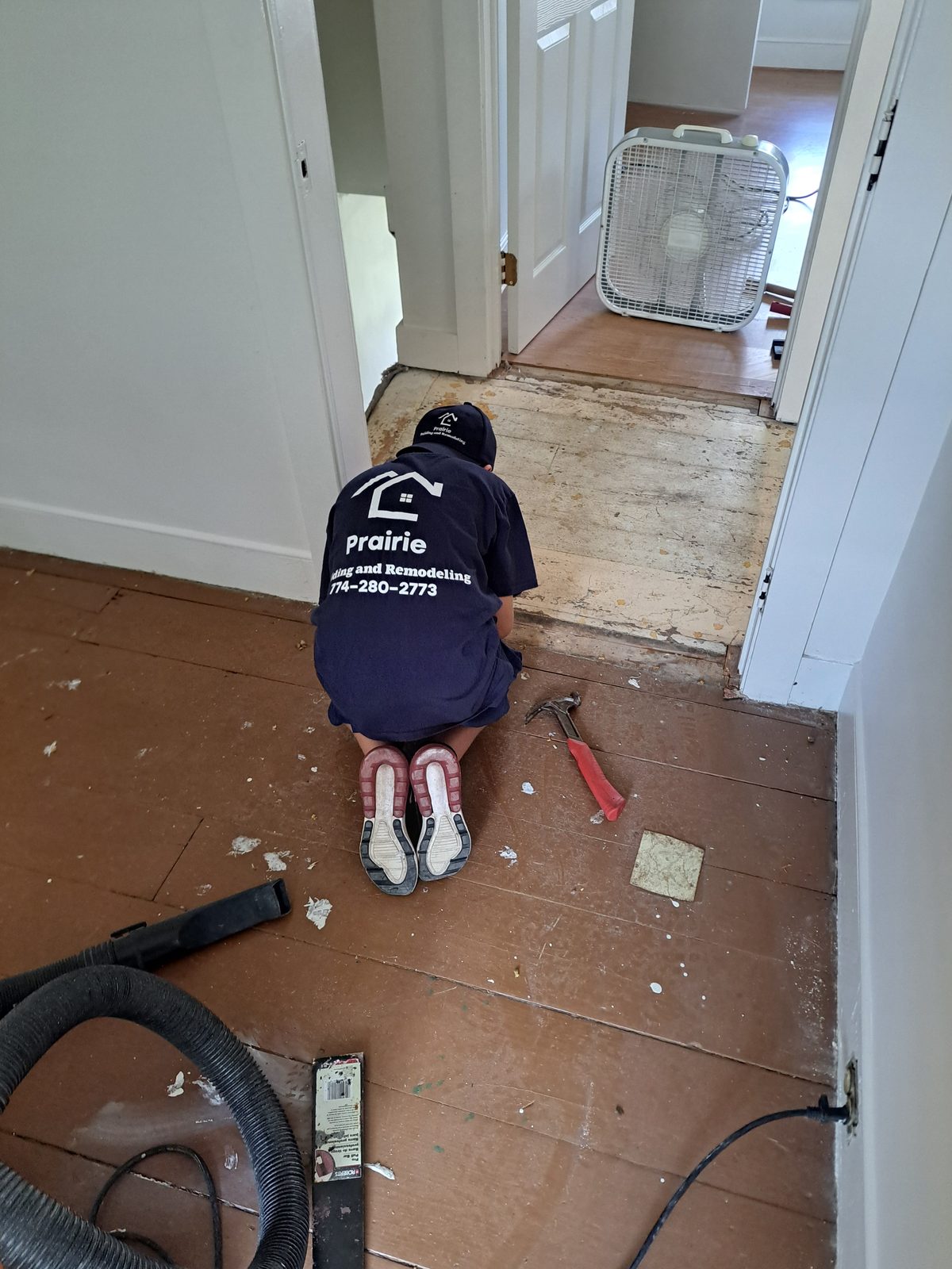 Before — Prairie Building crew removing flooring during a Sutton, MA remodel
