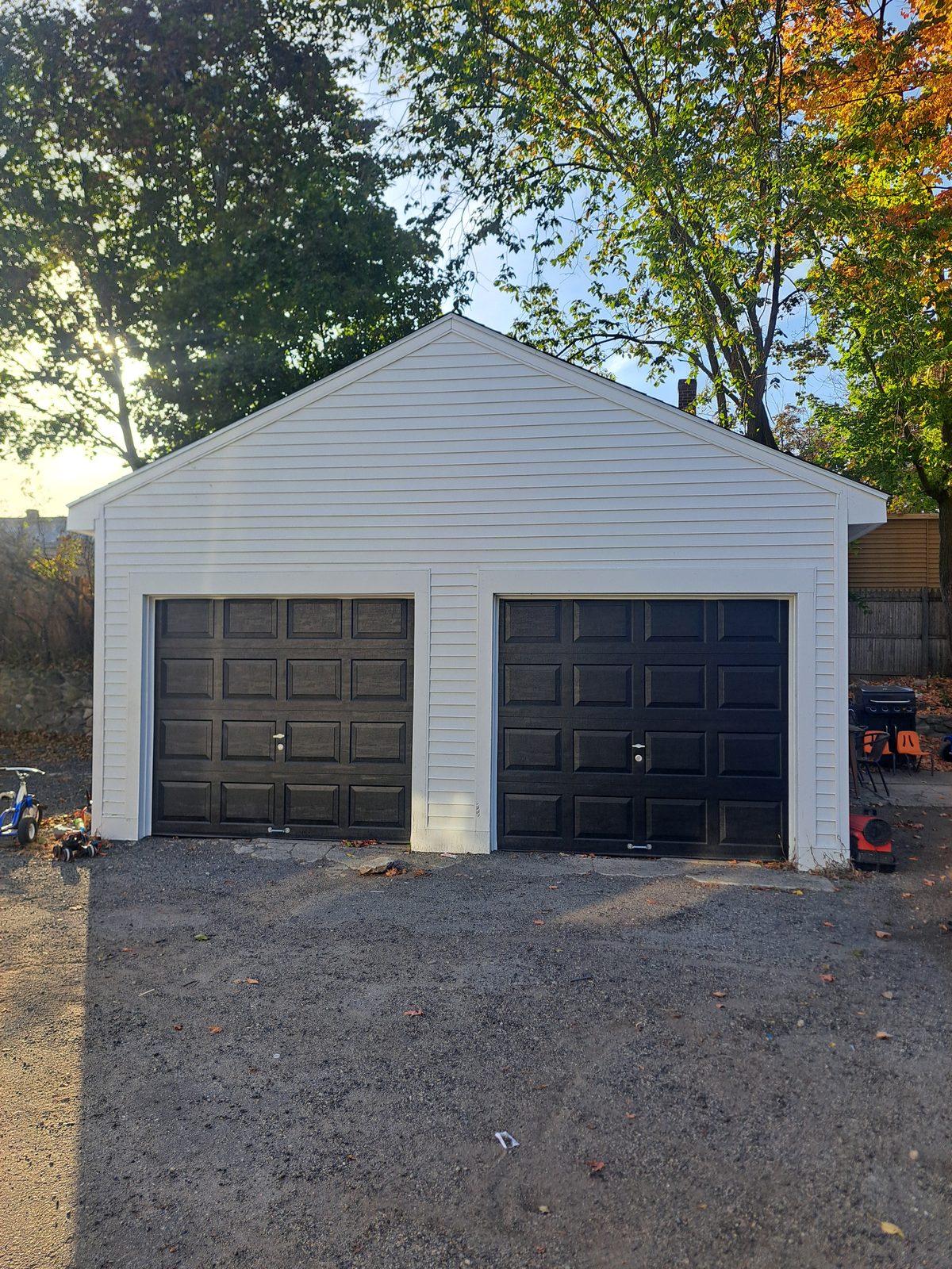 After — finished two-car garage with black doors in Sutton, MA