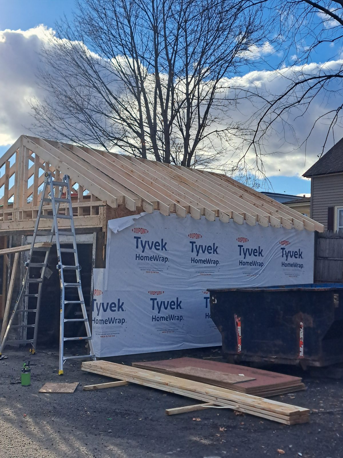 Before — garage roof framing and Tyvek wrap by general contractor Sutton, MA