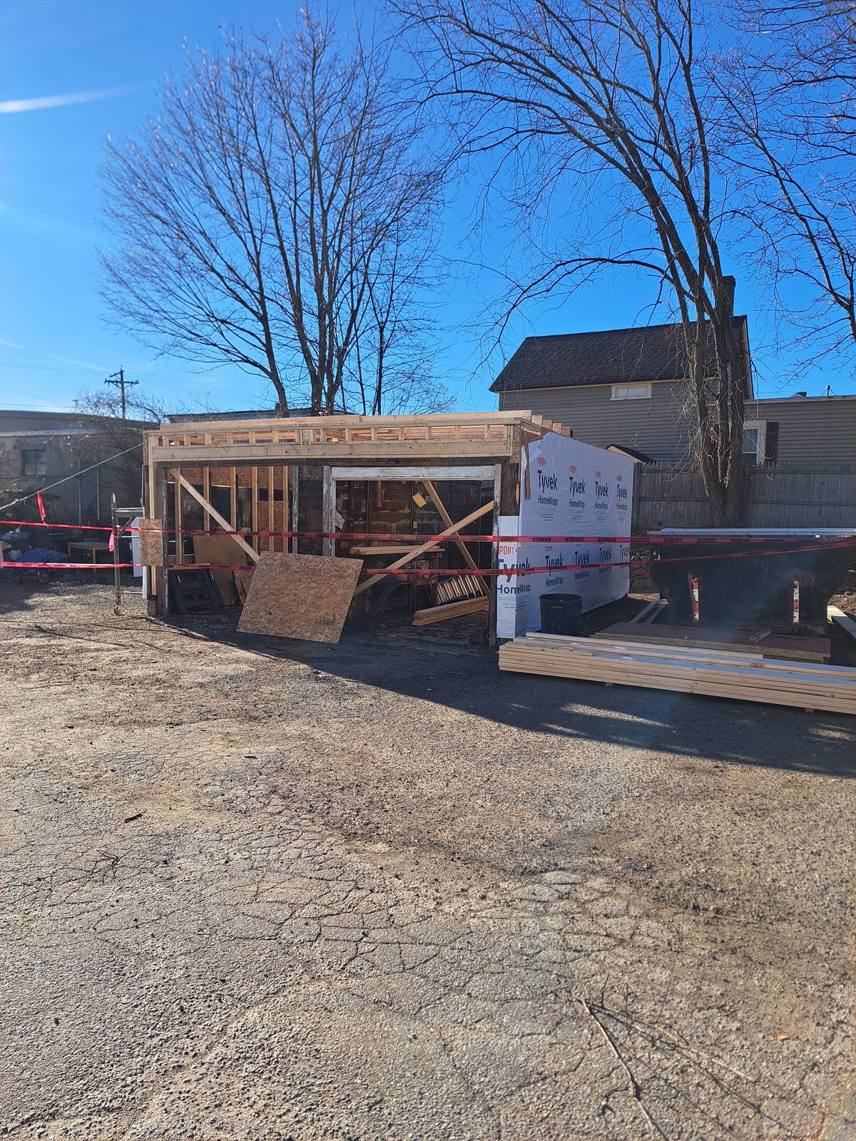 Before — garage addition framing with house wrap in Sutton, MA