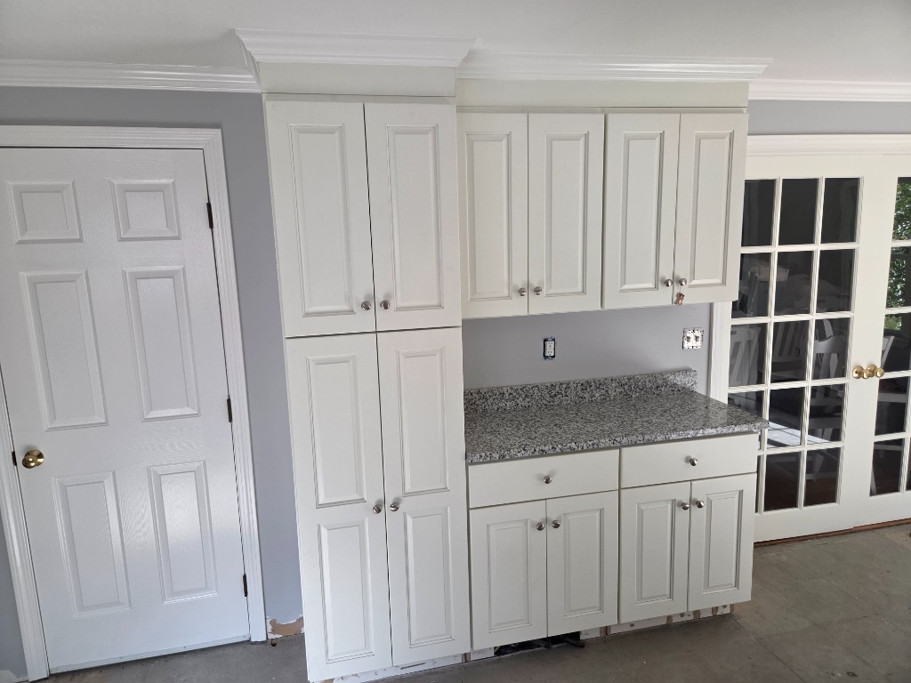 After — white kitchen cabinets and granite counter in a Sutton, MA kitchen remodel