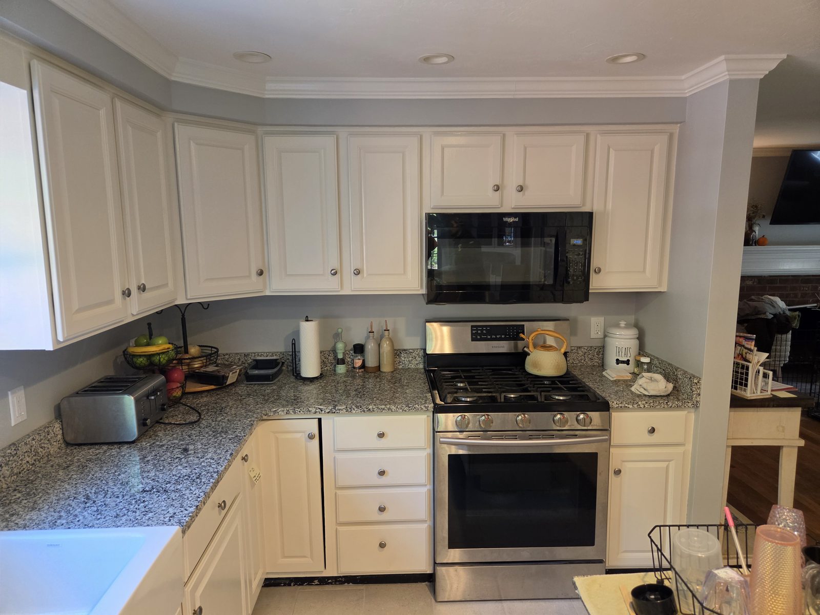 After — range, microwave, and white upper cabinets in a Sutton, MA kitchen