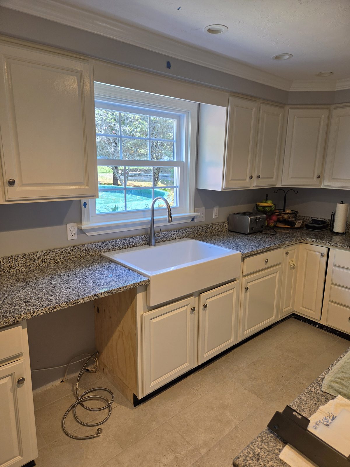 After — farmhouse sink and granite counters in a Sutton, MA kitchen remodel