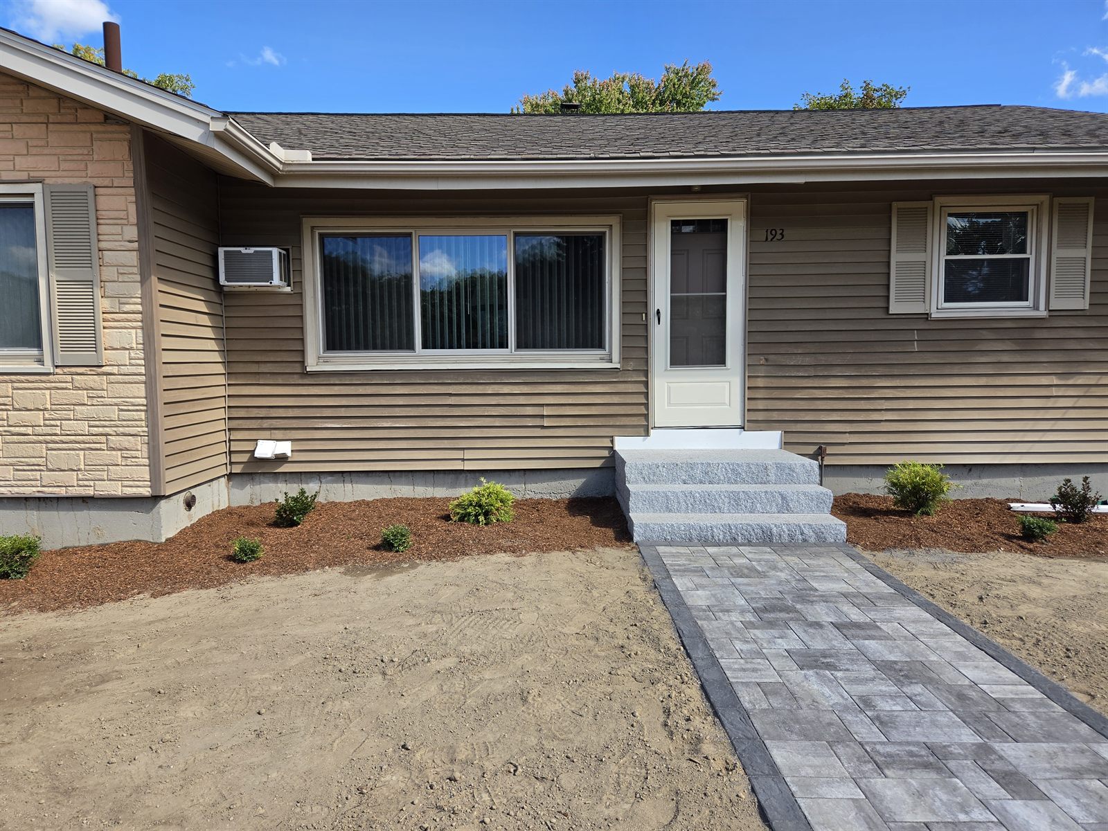After — completed exterior siding, steps, and walkway in Sutton, MA