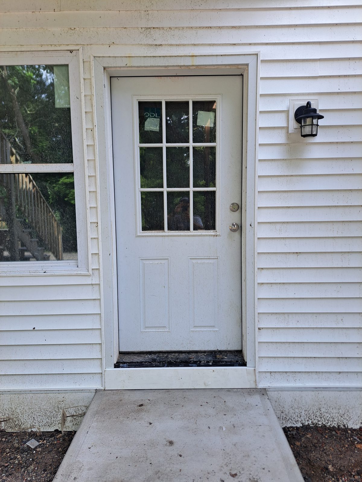 After — vinyl siding around an entry door in Sutton, MA