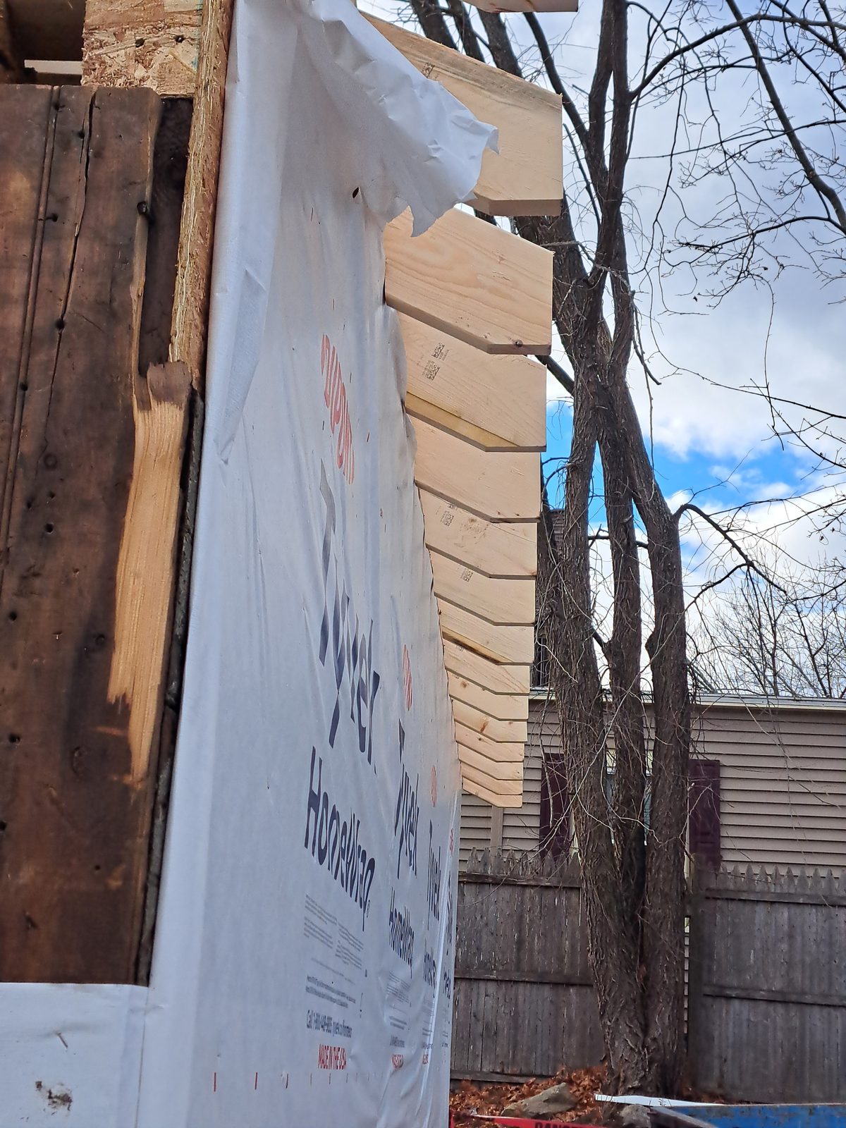 Before — house wrap and rafter tails during garage remodeling in Sutton, MA