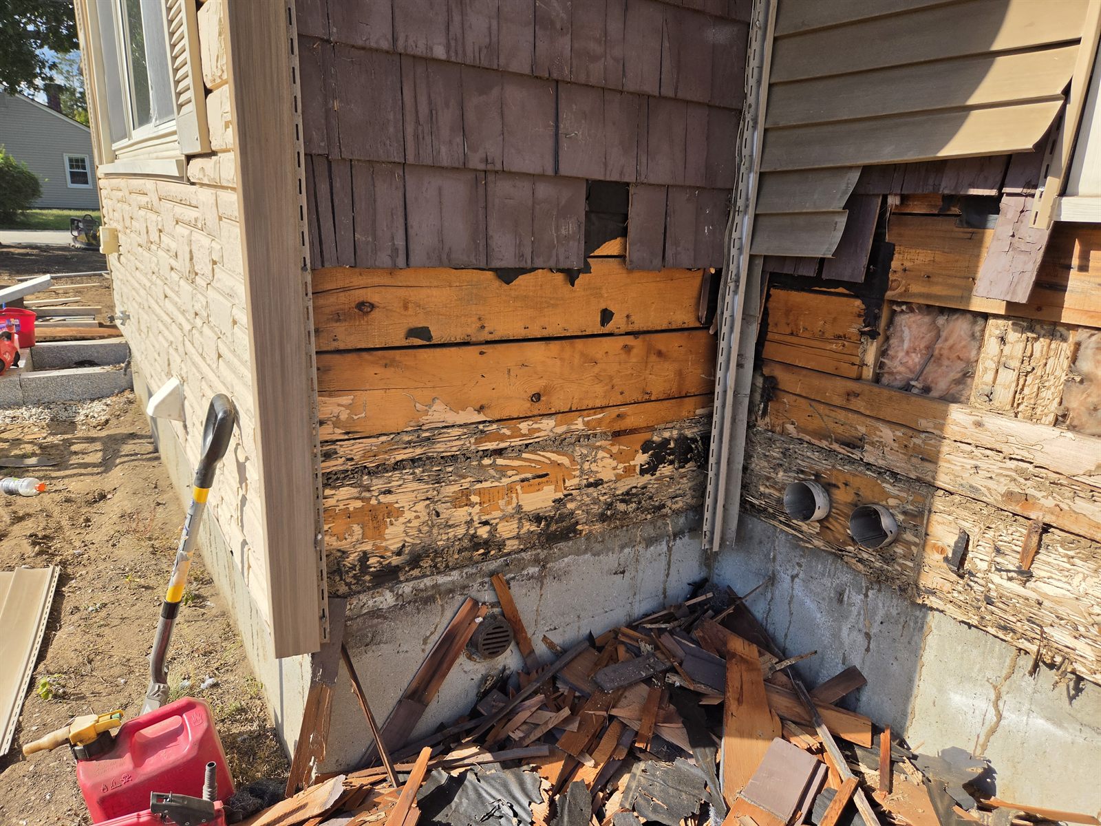 Before — rotted corner sheathing during exterior siding work in Sutton, MA
