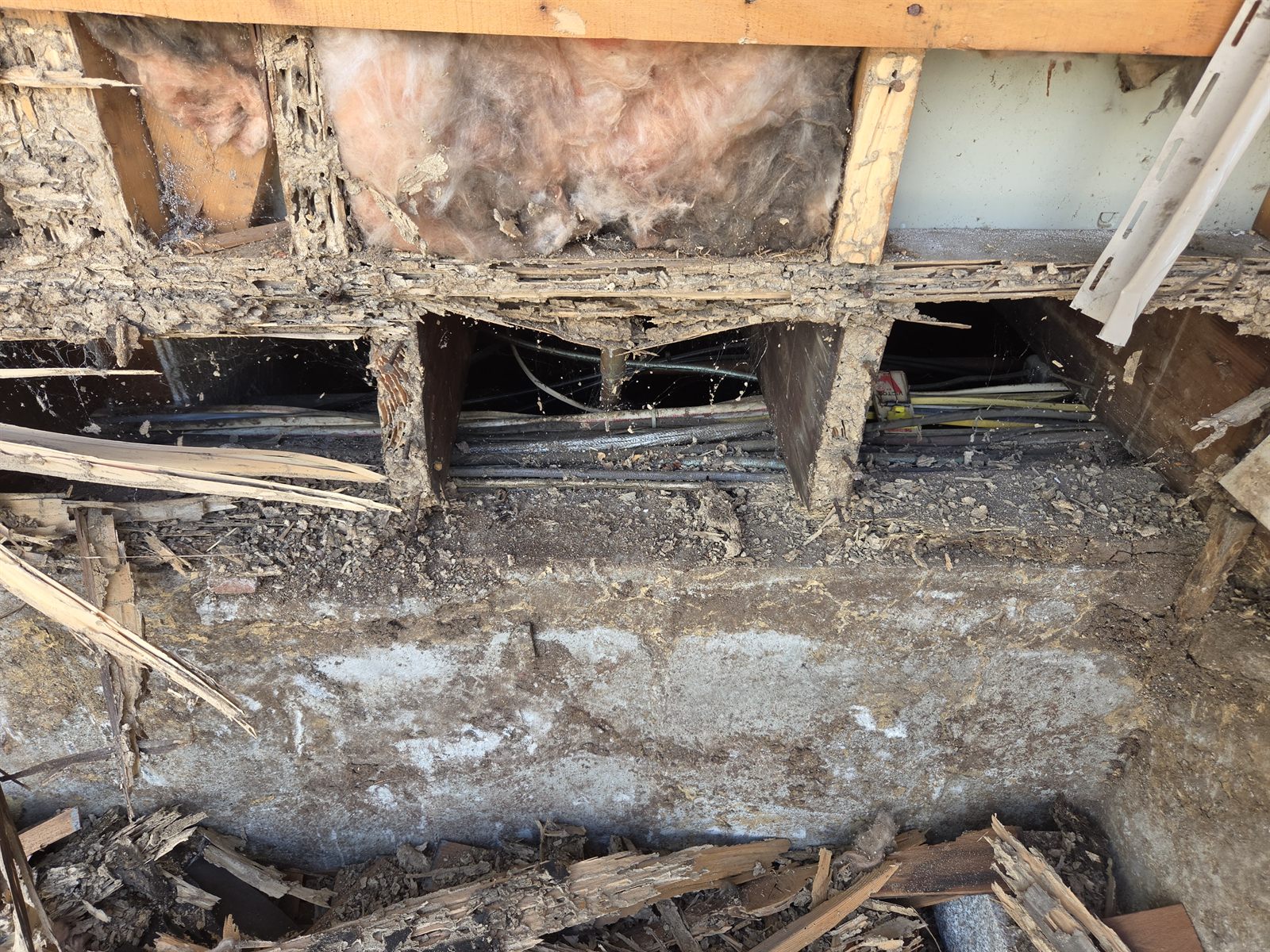 Before — open wall framing, insulation, and wiring during siding removal in Sutton, MA