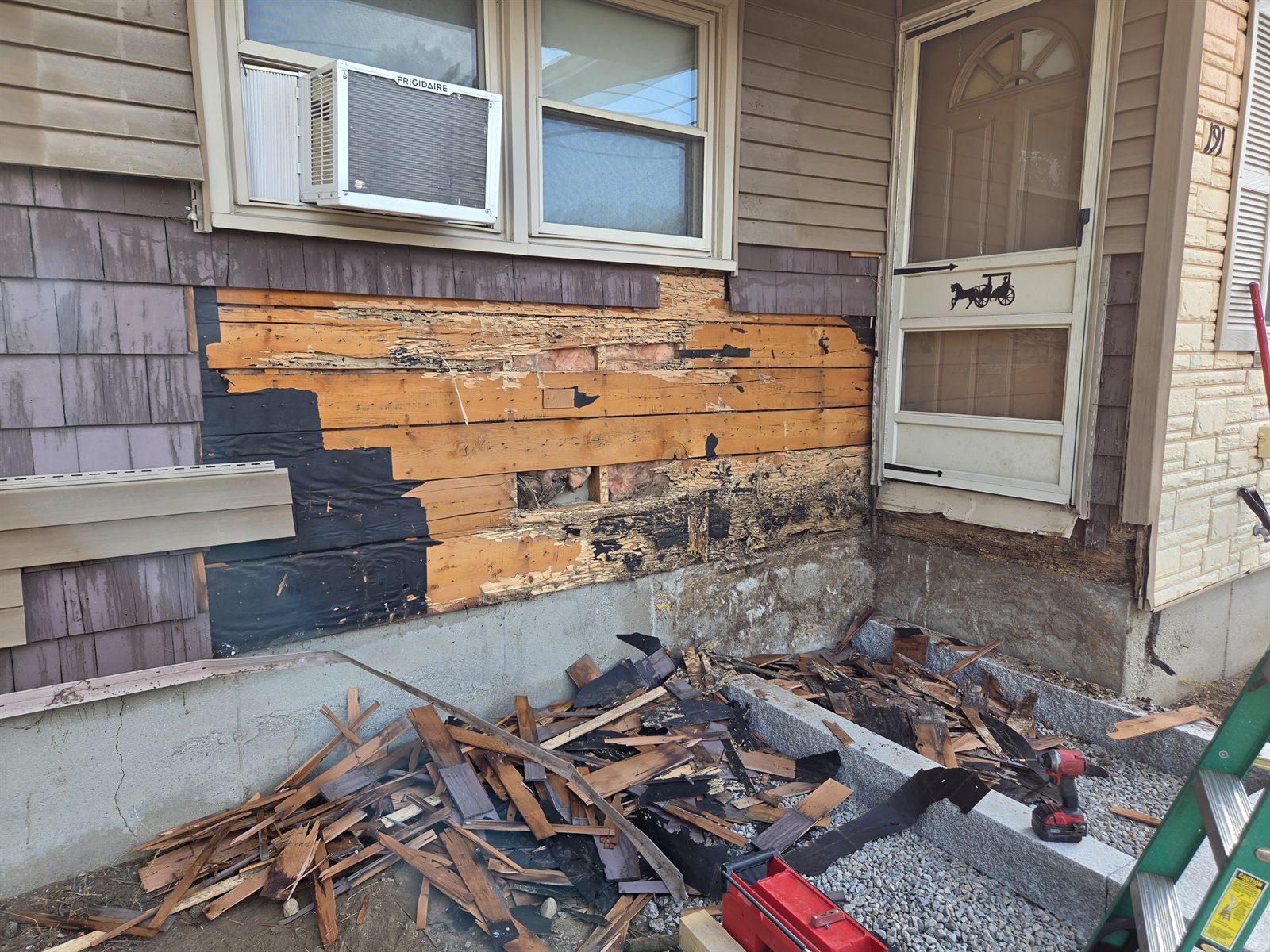 Before — rotten wall sheathing exposed during siding removal in Sutton, MA