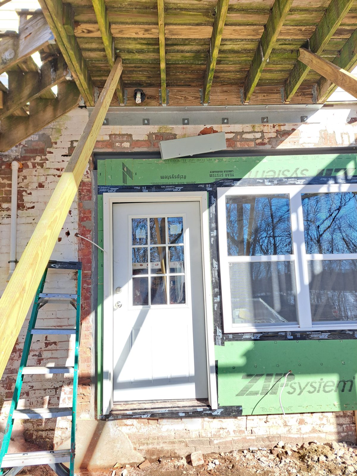 Before — exterior window installation with house wrap in Worcester County, MA